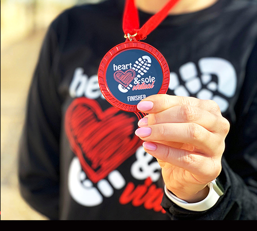 girl holding finisher medal